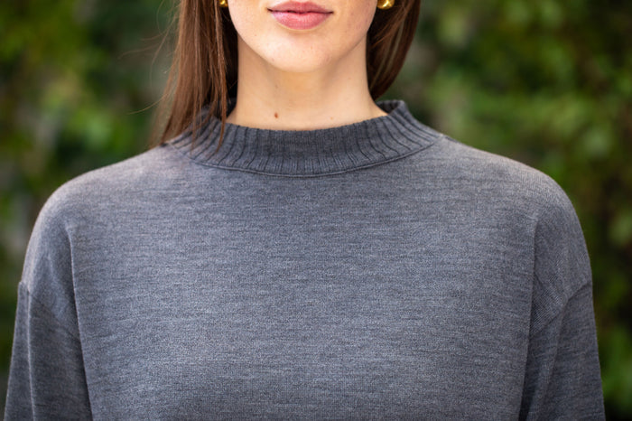 Woman wearing Country Laine - Slant Jumper (CL0115-IND2026) in the colour Dark Grey.