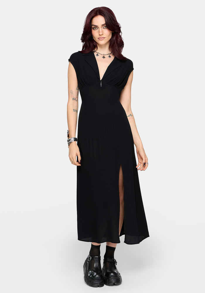 Woman wearing a black dress with a slit on a white background