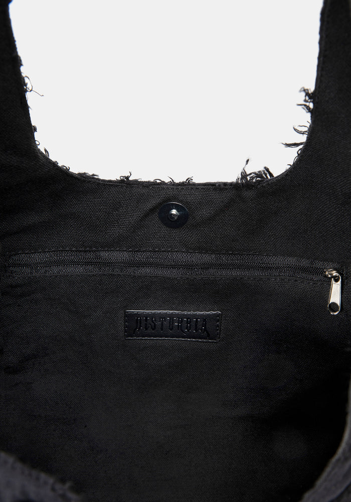 Close-up of a black bag with a brand logo on a white background